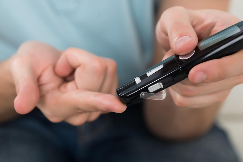 rely on glucose - person testing glucose levels on finger